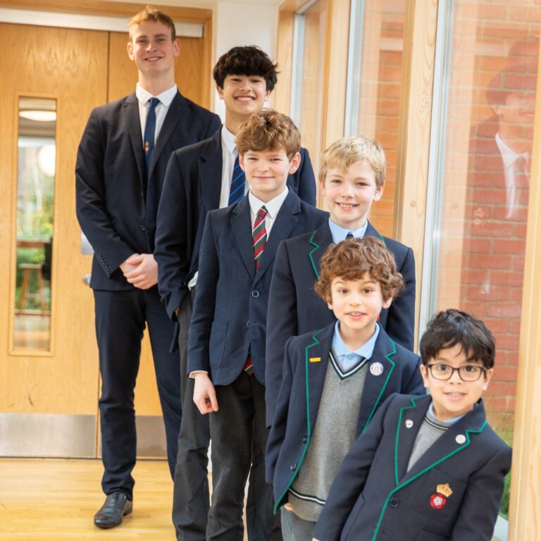 Image of boys from 3 to 18 in a corridor